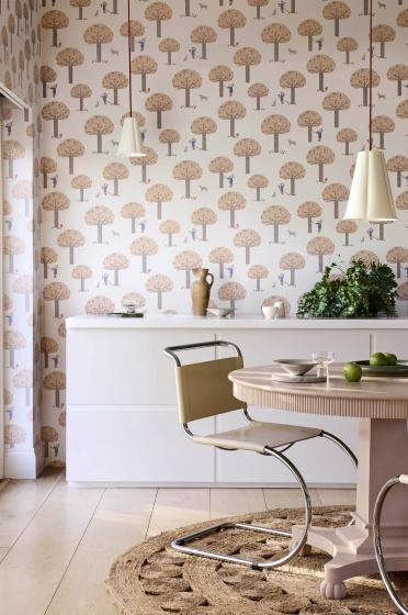 Dining room featuring pale pink tree print wallpaper (Rodney Street - Masquerade) with a white cabinet, dining room table and chairs.