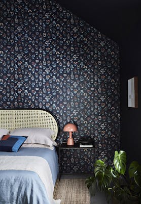 Bedroom with blue small floral wallpaper 'Millefleur - Knight' and deep blue 'Basalt' walls.