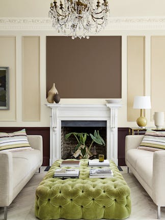 Sitting room with a neutral beige (Clay - Mid) wall and panelling in deep stone, pale brown and fawn colors, and two sofas.