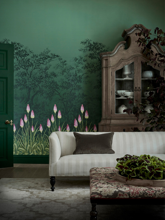 Living room with forest green wallpaper featuring kniphofia flowers and dark green (Dark Brunswick Green) baseboards,