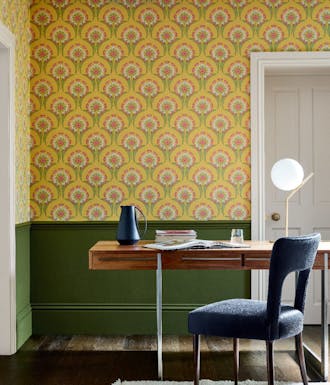 Home study space with the lower wall painted in deep green and yellow floral wallpaper (Hencroft - Punch) on the upper wall.