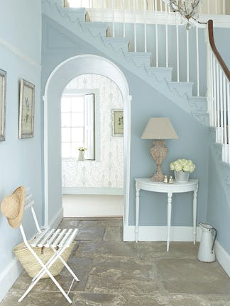 Hallway featuring walls painted in multiple shades of 'Bone China Blue' and a console table painted in 'Shirting'.