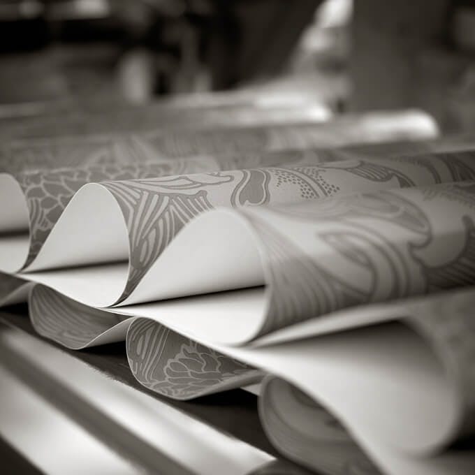 Close-up of multiple pieces of wallpaper folded in the same pattern.