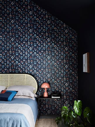 Bedroom with blue small floral wallpaper 'Millefleur - Knight' and deep blue 'Basalt' walls.