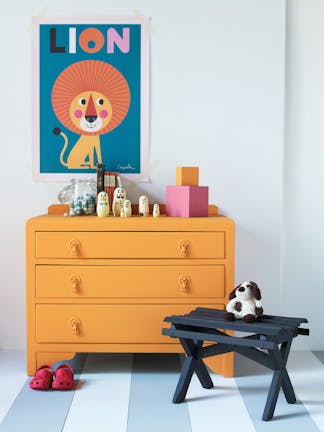 Nursery featuring bright orange drawers (Marigold) and cartoon lion artwork on contrasting grey walls (Bone China Blue).