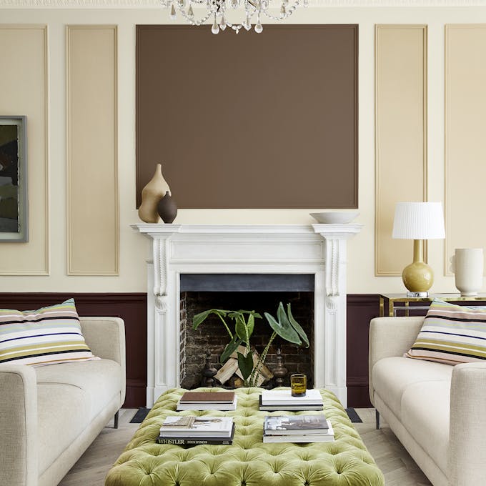 Sitting room with a neutral beige (Clay - Mid) wall and panelling in deep stone, pale brown and fawn colors, and two sofas.