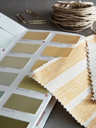 Colours of England Colourcard open revealing a variety of paint swatches in yellow, beige and light blue.