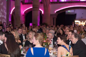 People sat around tables at the Confetti Ball at The Monastery in Manchester, to support Breast Cancer Haven.