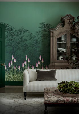 Living room with forest green wallpaper featuring kniphofia flowers and dark green (Dark Brunswick Green) baseboards.