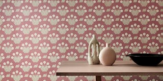 Dining room with pink printed snail wallpaper (Burges Snail - Rosie) behind a wooden dining room table.