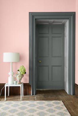 Doorway entrance with a grey green (Livid) painted door and doorframe with a contrasting pale pink (Confetti) wall.