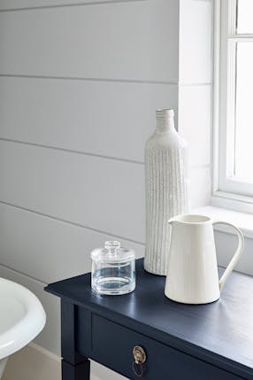 Bathroom painted in dark grey (Gauze - Dark) with a contrasting blue black (Basalt) side table.