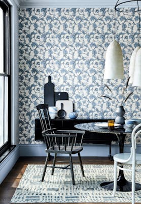 Dining room with a blue and off-white Georgian style wallpaper (Stag Trail - Sky) with a table and chairs.