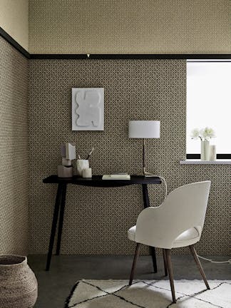 Indoor study with two shades of small scale wallpaper 'Moy' (Lime and Pompei) with a black desk and white chair.