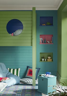 Panelled children's bedroom painted in turquoise 'Canton' and deep green 'Garden' with three shelves and a bunk bed.