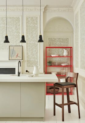 Kitchen counter with neutral green floral wallpaper (Briar Rose - Green Stone) and neutral green paint on the walls.