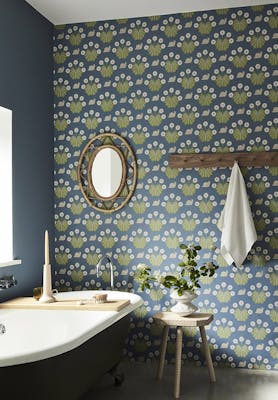 Bathroom with snail-printed wallpaper (Burges Snail - Juniper) on back wall and deep blue (Juniper Ash) on right wall.