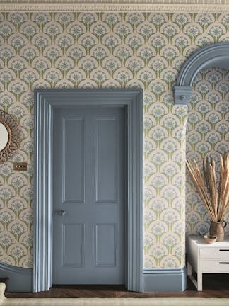 Hallway with blue and pink floral wallpaper (Hencroft - Blue Primula) and matching door and woodwork painted in blue grey.