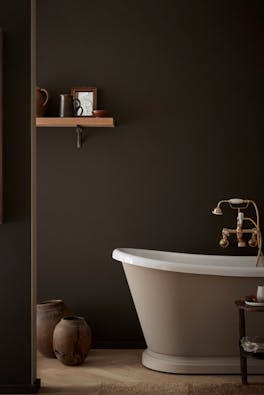 Bathroom colour drenched in deep brown shade 'Chocolate Colour' with a contrasting neutral (Rolling Fog - Dark) bath tub with gold taps.