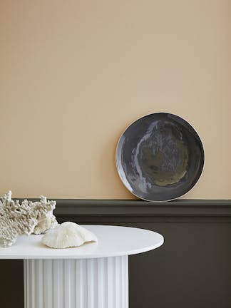 Pale brown neutral hallway (Lute) with lower wall painted in grey green (Pompeian Ash) and a white side table.