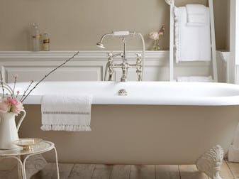 Bathroom with walls, bathtub and panelling painted in various shades of Rolling Fog, a collection of neutral brown paints.