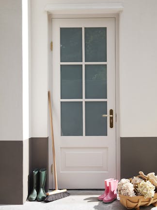 A front door painted in the off-white grey shade 'Down', with the house exterior in neutral brown 'Attic II'.