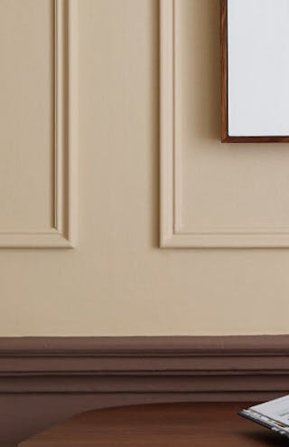 Warm neutral (Castell Pink) home study area with a red (Arras) door next to a wooden desk and chair.