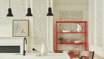 Kitchen counter with neutral green floral wallpaper (Briar Rose - Green Stone) and neutral green paint on the walls.