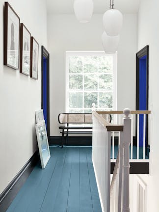 Hallway with an Air Force Blue painted floor, contrasting white (Shallows) walls and a window at the end of the corridor.