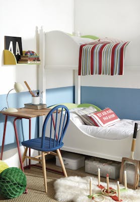 Children's bedroom with white bunk beds and the lower wall painted in pale blue 'Tivoli' with toys, a small desk and chair.