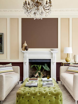 Sitting room with a neutral beige (Clay - Mid) wall and panelling in deep stone, pale brown and fawn colors, and two sofas.