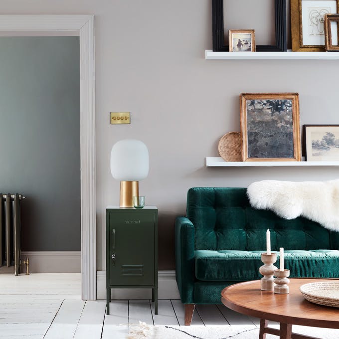 Velvet forest green sofa in front of a light grey (French Grey) wall and on top of bright white wood flooring in Loft White.