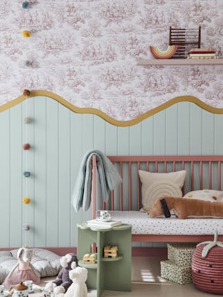 Child's playroom with ‘Lovers' Toile – Blush’ on the upper wall and ‘Aquamarine – Mid’ on the lower wall with a pink bench and toys on the floor.