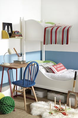 Children's bedroom with white bunk beds and the lower wall painted in pale blue 'Tivoli' with toys, a small desk and chair.