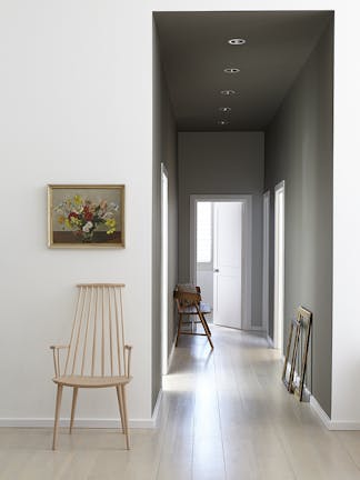 A narrow corridor with walls painted in dark grey (Baluster and Cool Arbour), and an off-white wall (Wood Ash) in the foreground. 