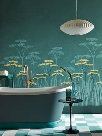 Bathroom with dark green (Harley Green) bath in front green floral mural wallpaper and yellow accents (Achillea - Aurora).