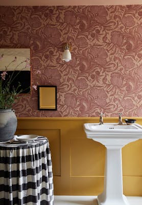 Bathroom with pink floral wallpaper (Poppy Trail - Masquerade) on the upper wall and yellow on the bottom half (Yellow-Pink).