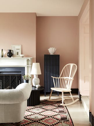 Pale pink living room in varying shades of 'Masquerade', alongside a rocking chair, sofa and Aztec rug.