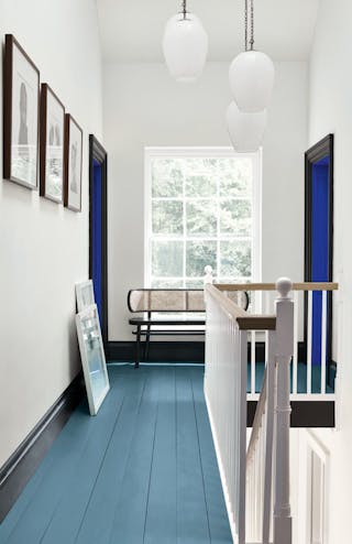 Hallway with an Air Force Blue painted floor, contrasting white (Shallows) walls and a window at the end of the corridor.