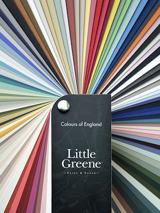 Little Greene colours of England Fan Deck in the bottom-middle, with color samples spiraling around it in a rainbow pattern.