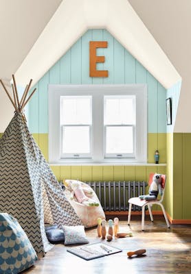 Children's playroom with a teepee, skittles and toys with a pale blue (Brighton) and bright green (Pale Lime) panelled wall.