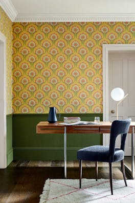 Home study space with the lower wall painted in deep green and yellow floral wallpaper (Hencroft - Punch) on the upper wall.