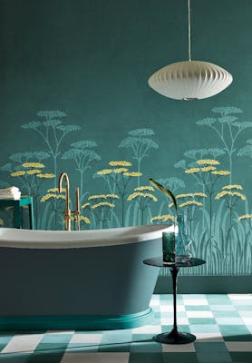 Bathroom with dark green (Harley Green) bath in front green floral mural wallpaper and yellow accents (Achillea - Aurora).