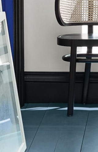 Hallway with an Air Force Blue painted floor, contrasting white (Shallows) walls and a window at the end of the corridor.