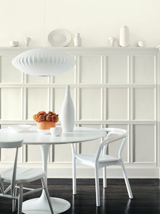 Dining room with French Grey - Dark, French Grey, and French Grey - Mid panelling and a white table and two vases.