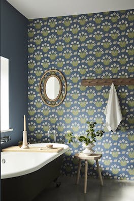 Bathroom with snail-printed wallpaper (Burges Snail - Juniper) on back wall and deep blue (Juniper Ash) on right wall.