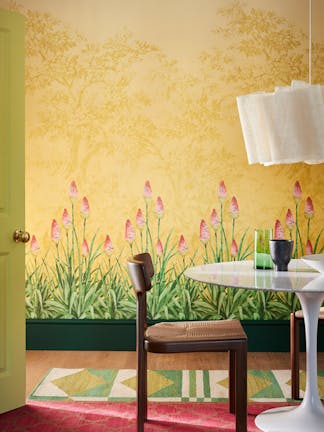 Dining room with yellow mural wallpaper (Upper Brook Street - Soleil) and a dining room table with wooden chairs.