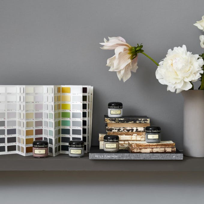 Five Little Greene paint samples and Color Card in front of a grey background with white and light pink flowers on the side.