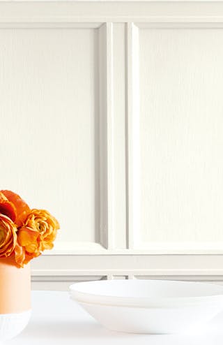 Close up of white pannelled wall in French Grey - Dark, French Grey, and French Grey - Mid, with a dining table and vases