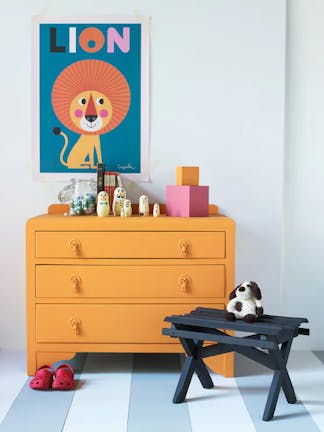 Nursery featuring bright orange drawers (Marigold) and cartoon lion artwork on contrasting grey walls (Bone China Blue).